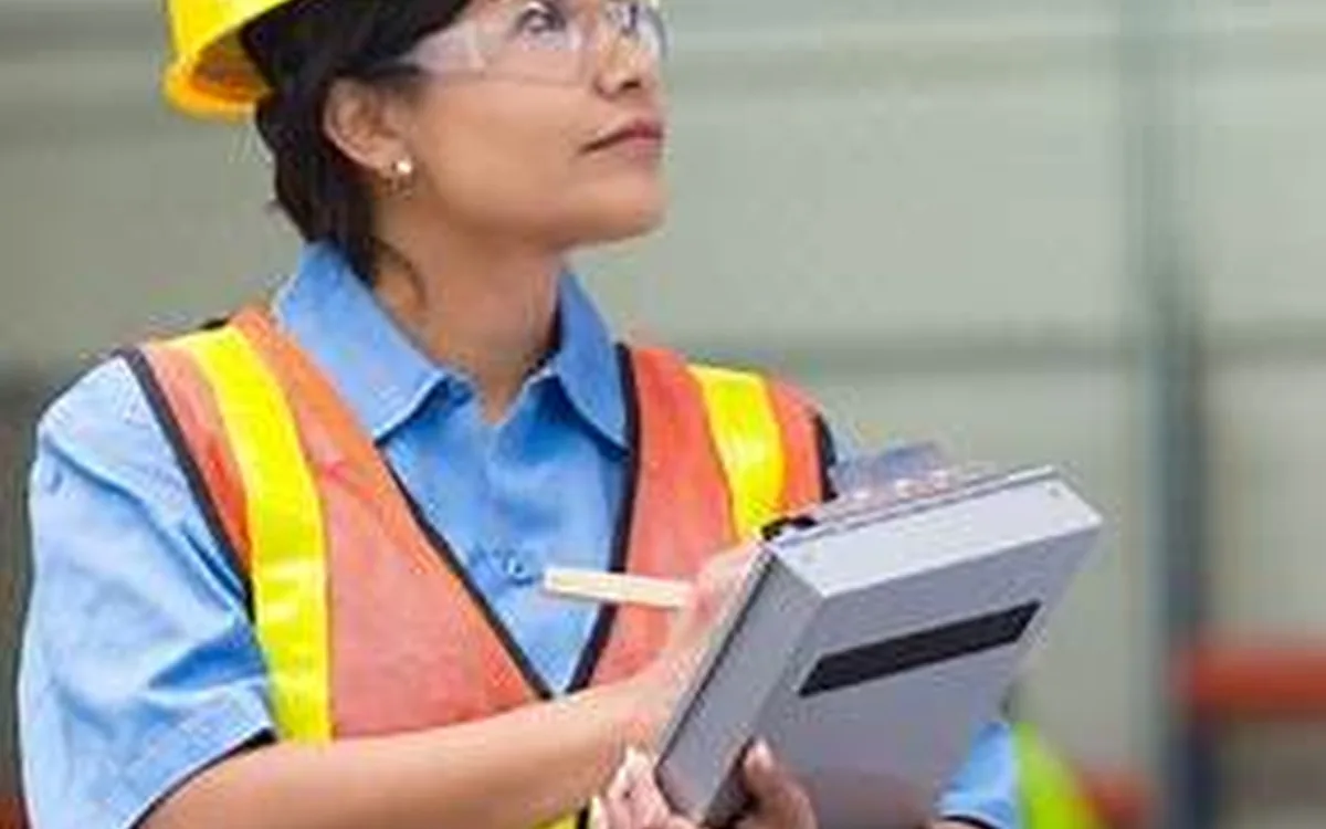 Profissional de segurança do trabalho realizando inspeção com prancheta